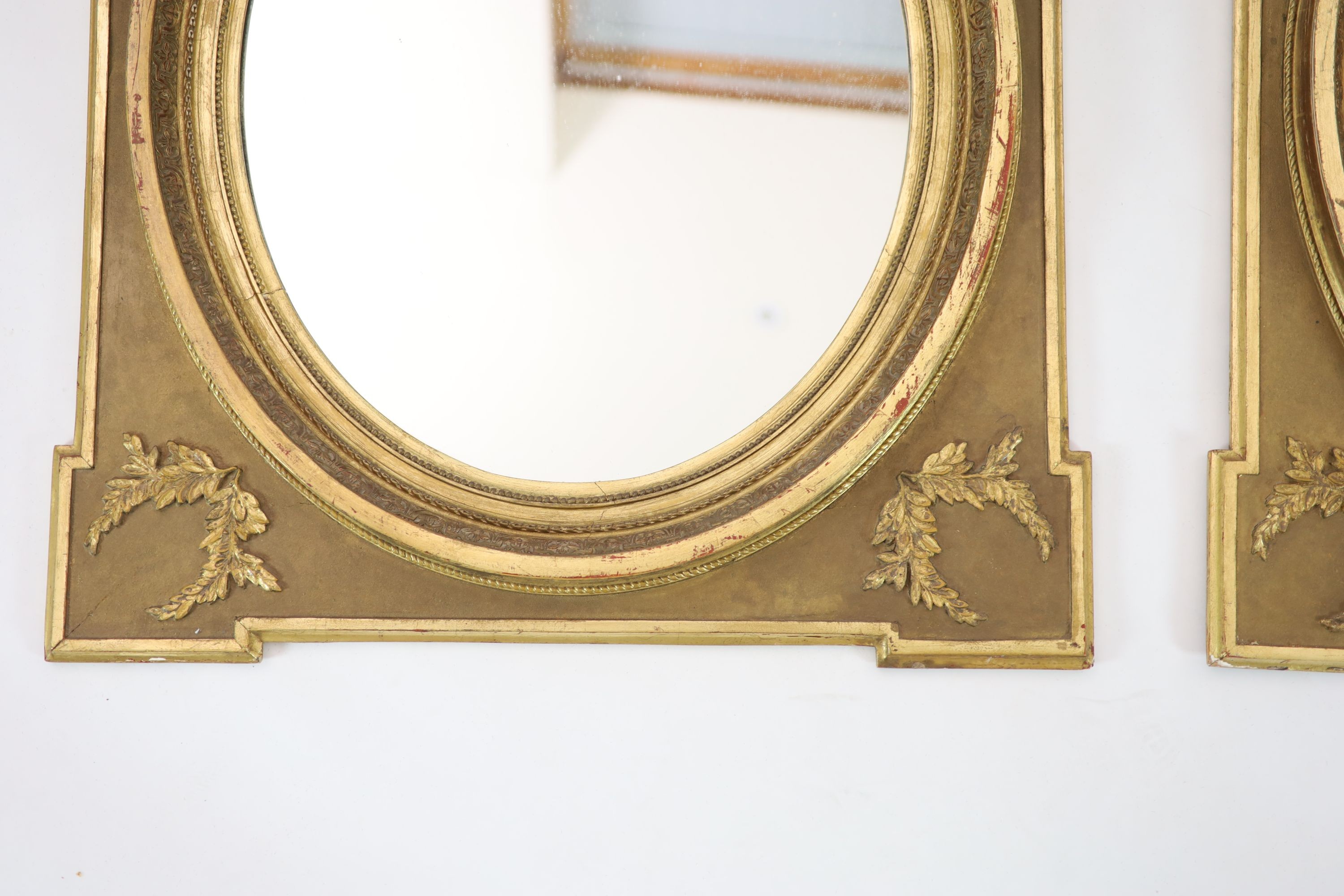 A pair of giltwood wall mirrors, of square form with oval plates, width 85cm, height 98cm
